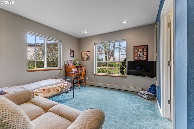 living area with carpet floors and a baseboard heating unit