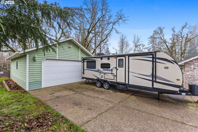 garage with a garage door opener, washer and clothes dryer, and a workshop area