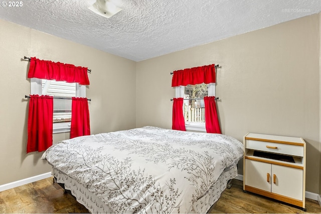 bedroom featuring hardwood / wood-style floors and a textured ceiling