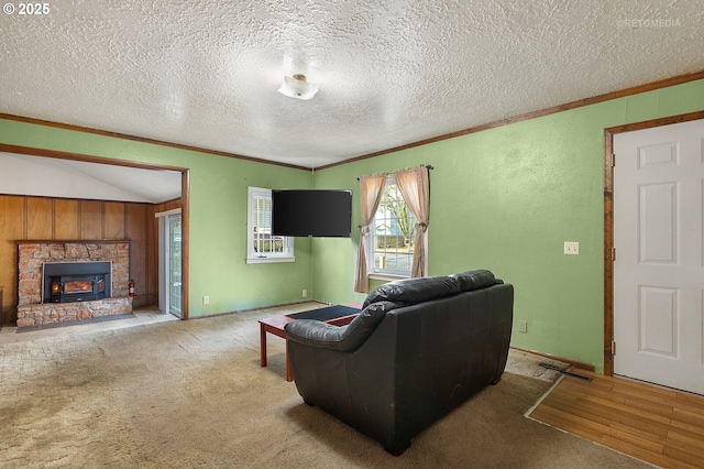 living room with crown molding, carpet flooring, a stone fireplace, and a textured ceiling