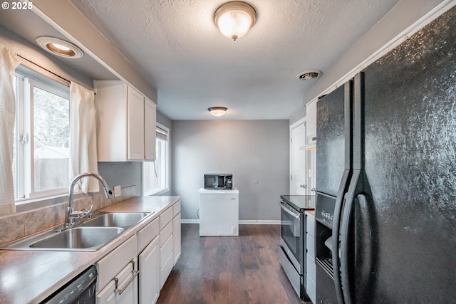 kitchen featuring white cabinetry, sink, dark hardwood / wood-style flooring, and black appliances