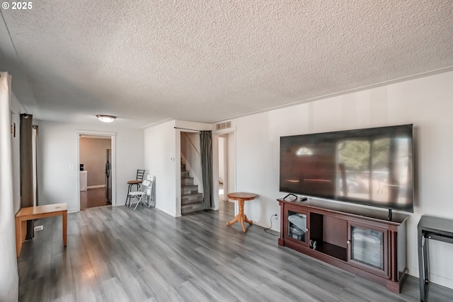 living room with hardwood / wood-style flooring and a textured ceiling