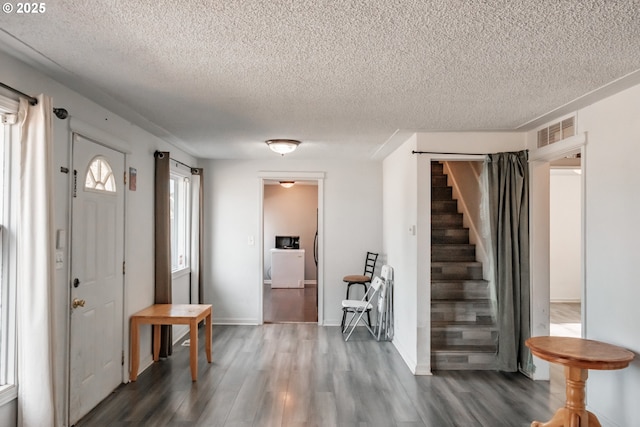 entrance foyer featuring dark hardwood / wood-style flooring and a textured ceiling