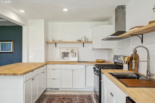 421 SE 141st Ave, Portland, OR 97233 - kitchen featuring open shelves, butcher block countertops, black range with gas cooktop, a sink, and wall chimney range hood