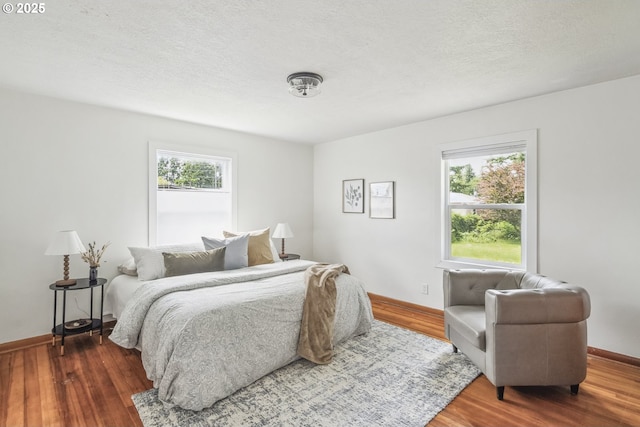 421 SE 141st Ave, Portland, OR 97233 - bedroom featuring wood finished floors, baseboards, and a textured ceiling