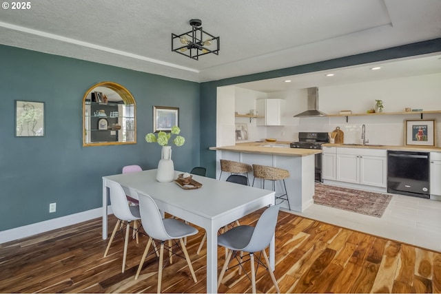 421 SE 141st Ave, Portland, OR 97233 - dining room featuring light wood-type flooring, baseboards, recessed lighting, and a chandelier