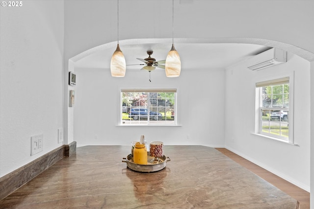 521 21st Ave, Longview, WA 98632 - dining area with arched walkways, a wall mounted air conditioner, plenty of natural light, and ceiling fan