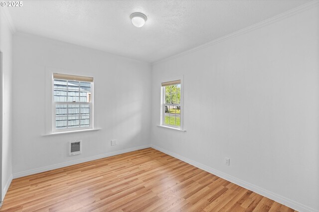 521 21st Ave, Longview, WA 98632 - unfurnished room featuring light wood-style floors, baseboards, crown molding, and a textured ceiling