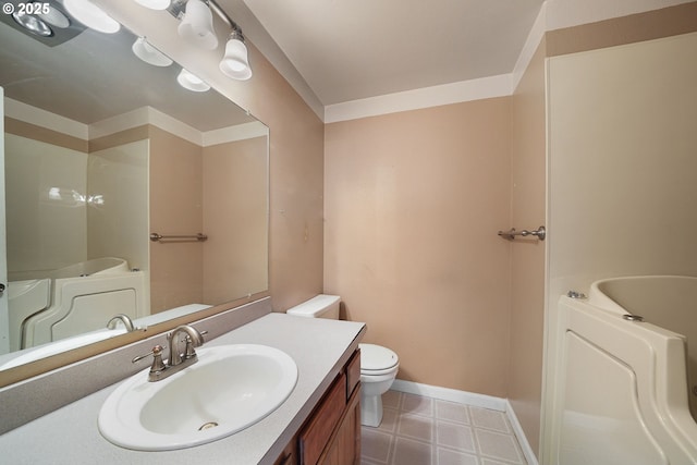 bathroom featuring vanity, a garden tub, toilet, and baseboards