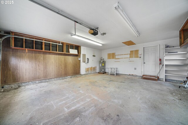 garage with a garage door opener and water heater
