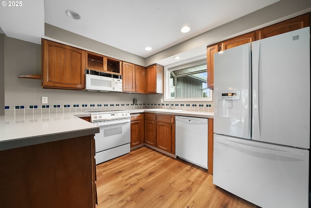 kitchen with open shelves, white appliances, brown cabinets, and light wood finished floors