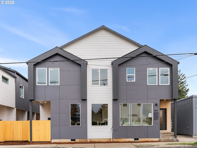 rear view of property featuring entry steps, crawl space, and fence