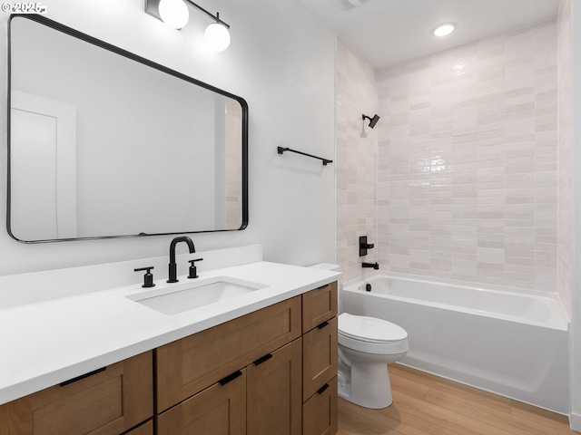 full bath featuring shower / bath combination, vanity, toilet, and wood finished floors