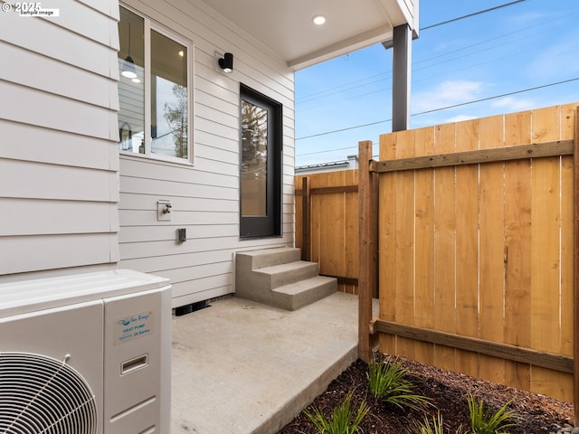 view of patio / terrace with ac unit, entry steps, and fence