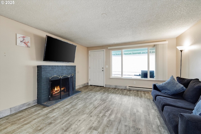 living area with a baseboard radiator, a textured ceiling, wood finished floors, and a fireplace