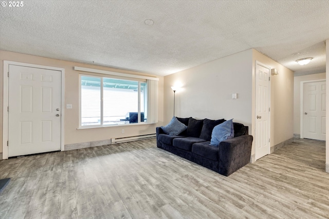 living room with a baseboard heating unit, wood finished floors, baseboards, and a textured ceiling