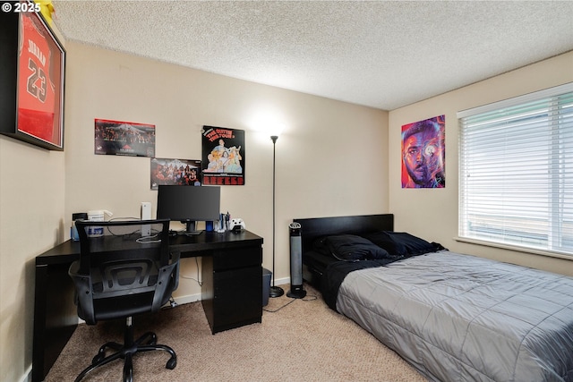 carpeted bedroom featuring a textured ceiling and baseboards