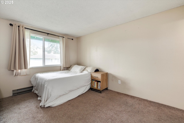 bedroom with a textured ceiling, carpet, and a baseboard radiator