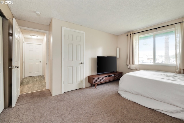 carpeted bedroom with a textured ceiling