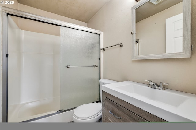 bathroom featuring vanity, a shower stall, and toilet