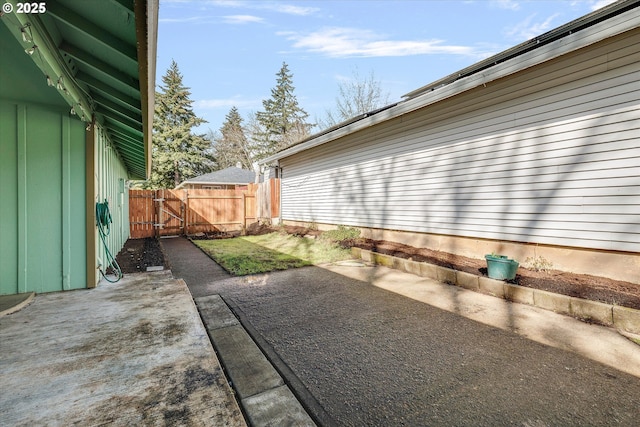 view of patio featuring fence and a gate