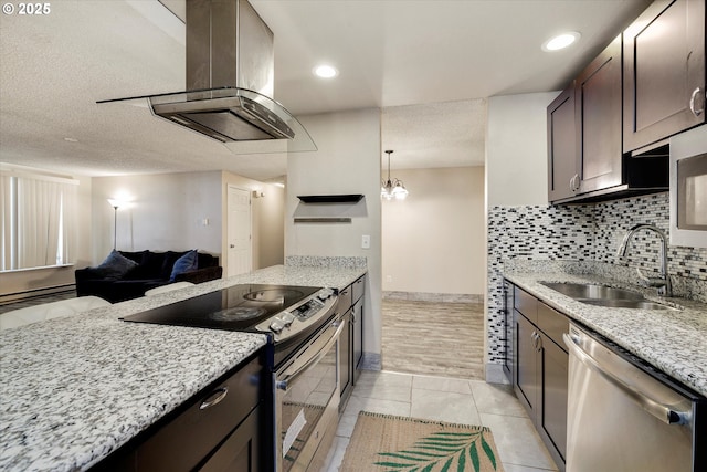 kitchen featuring island exhaust hood, a sink, dark brown cabinetry, appliances with stainless steel finishes, and tasteful backsplash