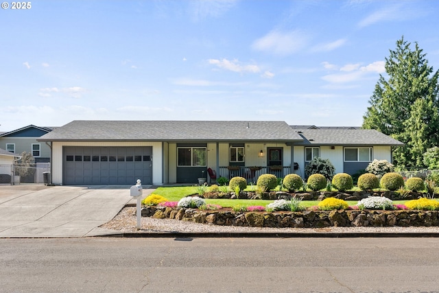 ranch-style house with a garage, fence, covered porch, and concrete driveway