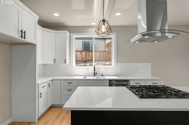 1405 Gordon Ct, The Dalles, OR 97058 - kitchen featuring island range hood, black gas stovetop, decorative backsplash, recessed lighting, and light wood finished floors