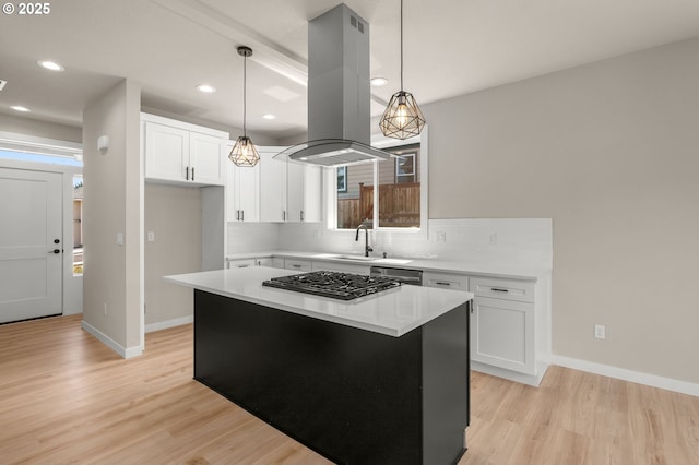 1405 Gordon Ct, The Dalles, OR 97058 - kitchen featuring island range hood, light wood-style flooring, white cabinets, gas cooktop, and recessed lighting
