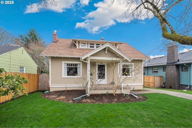 bungalow-style house with a shingled roof, a front yard, fence, and a chimney