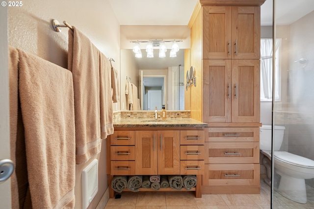 bathroom featuring vanity, toilet, visible vents, and tile patterned flooring