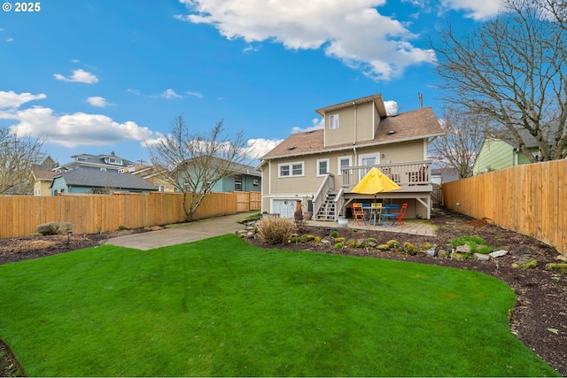 rear view of house featuring stairway, a patio area, a lawn, and a fenced backyard