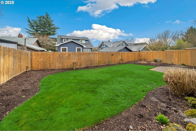 view of yard with a fenced backyard