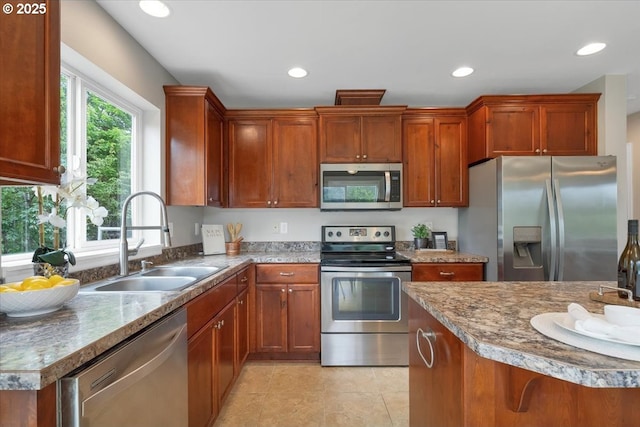21795 SE Grand Island Loop, Dayton, OR 97114 - kitchen featuring stainless steel appliances, recessed lighting, brown cabinetry, and light tile patterned floors