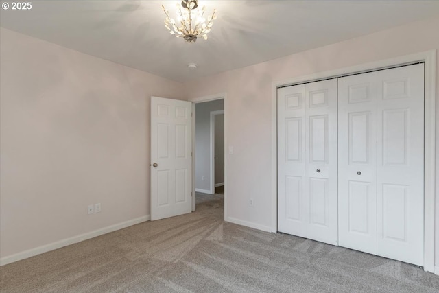 21795 SE Grand Island Loop, Dayton, OR 97114 - unfurnished bedroom featuring carpet flooring, a chandelier, and a closet
