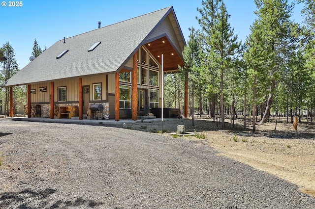 123604 Muttonchop St, Crescent Lake, OR 97733 - view of front of home featuring a shingled roof, driveway, and stone siding