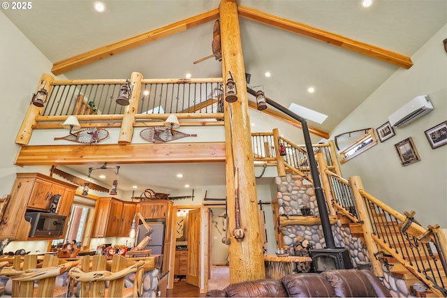 123604 Muttonchop St, Crescent Lake, OR 97733 - living room featuring high vaulted ceiling, beamed ceiling, a wall mounted air conditioner, a wood stove, and wood finished floors
