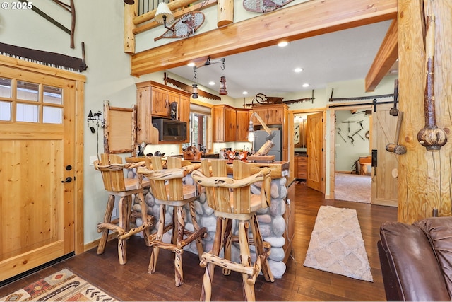 123604 Muttonchop St, Crescent Lake, OR 97733 - kitchen featuring a barn door, recessed lighting, dark wood-style floors, fridge, and beamed ceiling