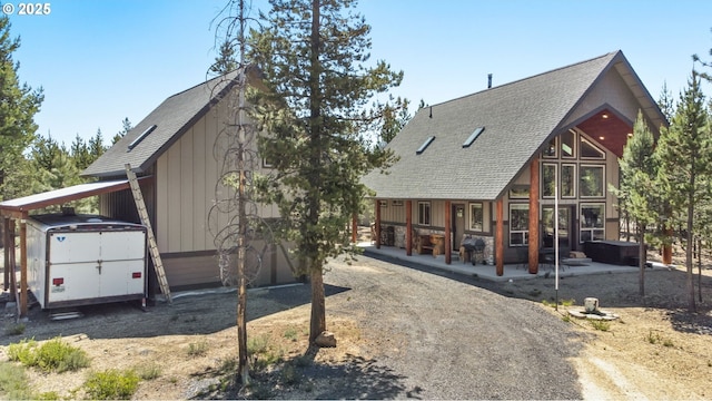 123604 Muttonchop St, Crescent Lake, OR 97733 - view of front of house with a jacuzzi, a storage unit, a patio area, and roof with shingles
