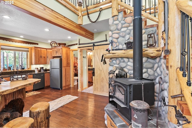 123604 Muttonchop St, Crescent Lake, OR 97733 - living area with a wood stove, recessed lighting, dark wood-style floors, and a barn door