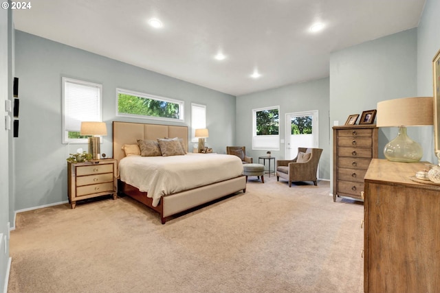 carpeted bedroom featuring multiple windows