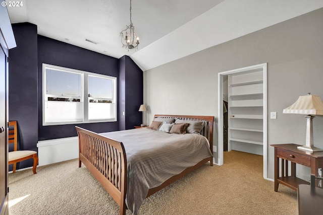 bedroom featuring lofted ceiling, a notable chandelier, a spacious closet, and light colored carpet