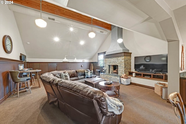 living room featuring beamed ceiling, a stone fireplace, light colored carpet, and high vaulted ceiling