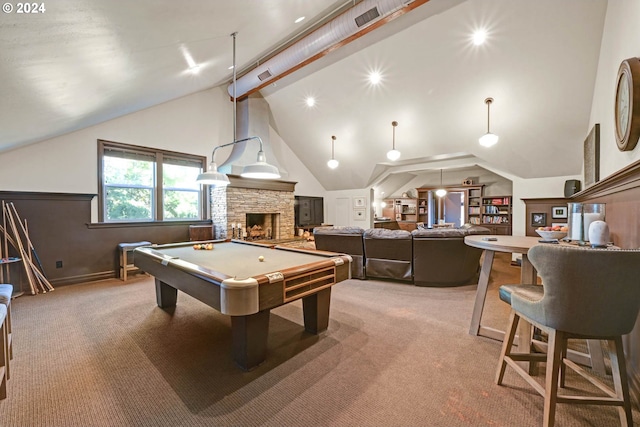 recreation room with light colored carpet, a stone fireplace, high vaulted ceiling, and pool table