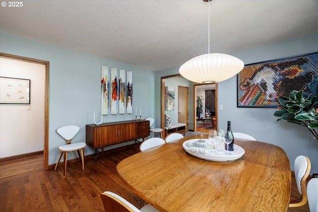 dining room with baseboards and wood finished floors