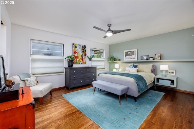bedroom with baseboards, ceiling fan, and wood finished floors