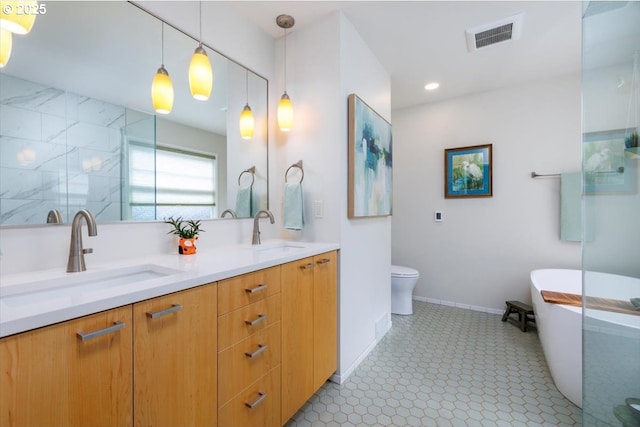 full bath with a sink, a shower stall, double vanity, and visible vents