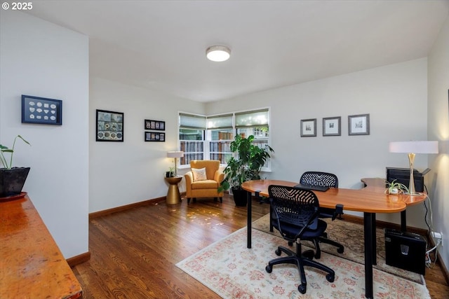 office space featuring baseboards and wood finished floors