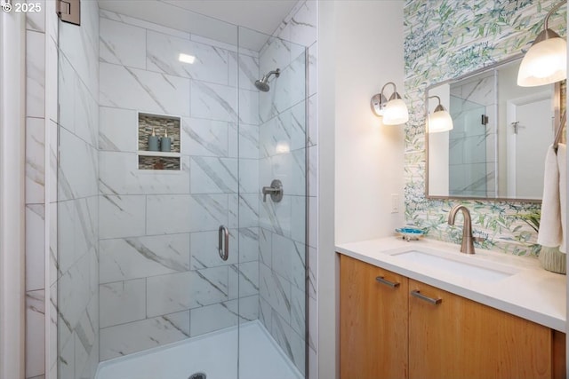 full bath with vanity, decorative backsplash, and a shower stall
