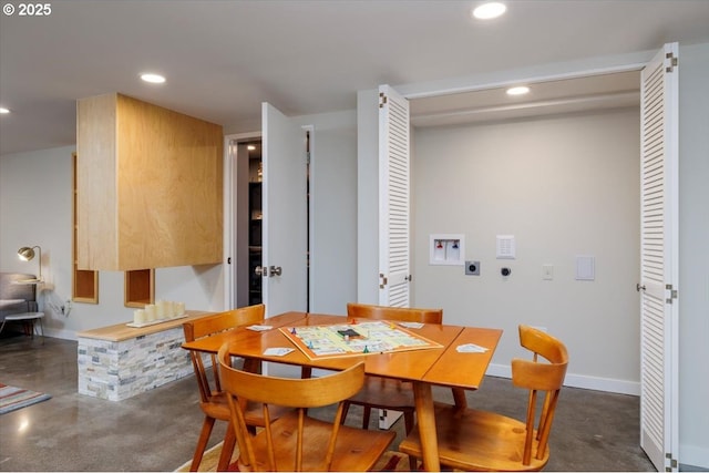 dining space featuring recessed lighting, finished concrete flooring, and baseboards